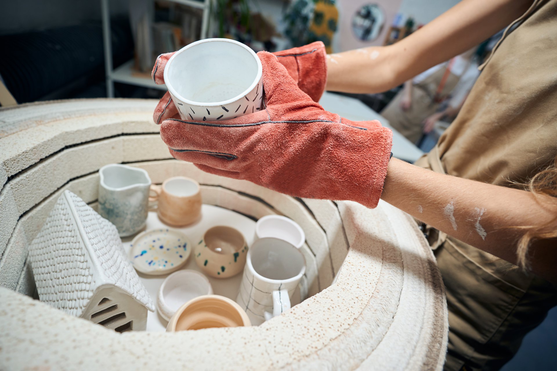unrecognizable-female-artisan-taking-glazed-mug-fr-2024-10-18-09-15-11-utc